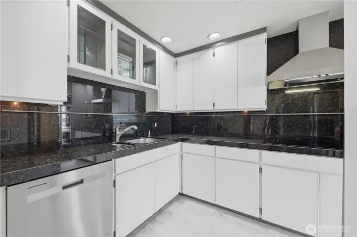 Lovely kitchen with plenty of counter space for the serious cook with slab stone & stainless-steel appliances. Lovely kitchen with plenty of counter space for the serious cook with slab stone & stainless-steel appliances.