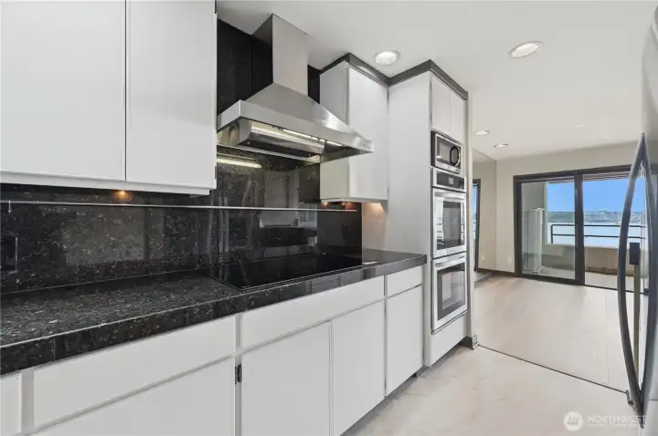 Brand new cooktop with double ovens, built-in microwave & refrigerator looking toward the sound views & gracious size dining space. Brand new cooktop with double ovens, built-in microwave & refrigerator looking toward the sound views & gracious size dining space.
