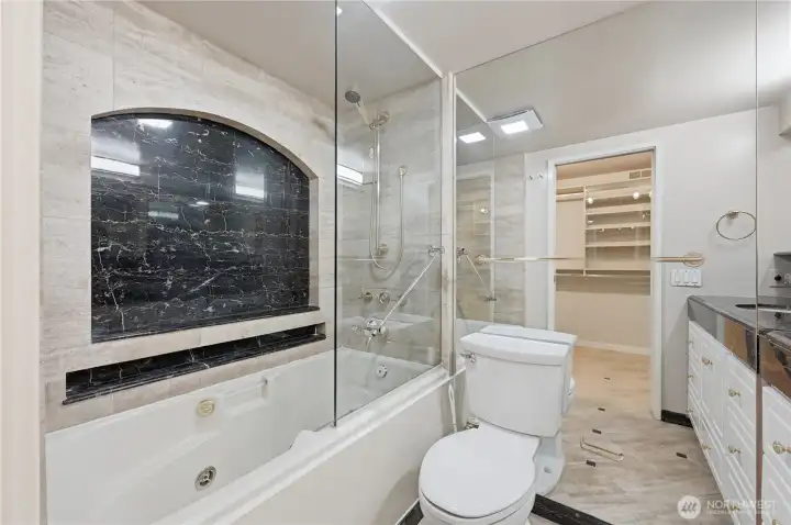 A spa like primary bath accented in stone, marble & mirrors. A spa like primary bath accented in stone, marble & mirrors.