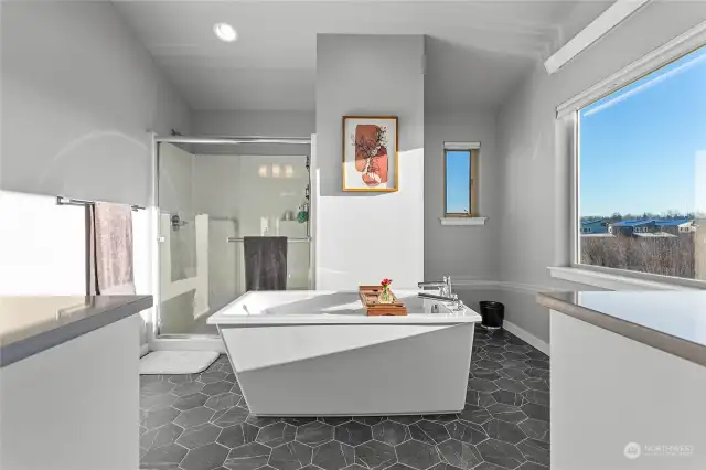 The soaking tub is the centerpiece of this amazing space, also with views of Mt. Baker. Bathing not your thing? Step into the oversized shower.