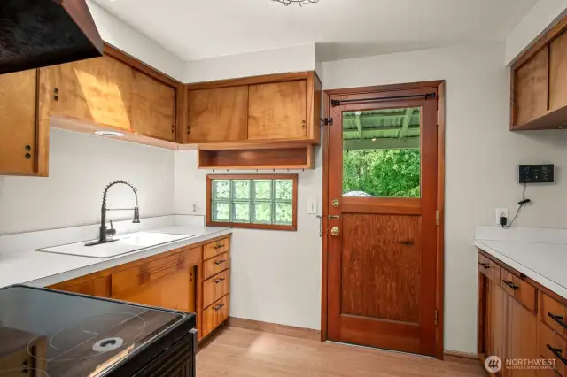 Second door to backyard through the quaint kitchen