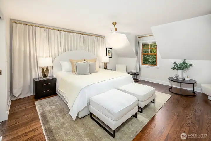 Gorgeous hardwood floors and generous space in this elegant primary ensuite.