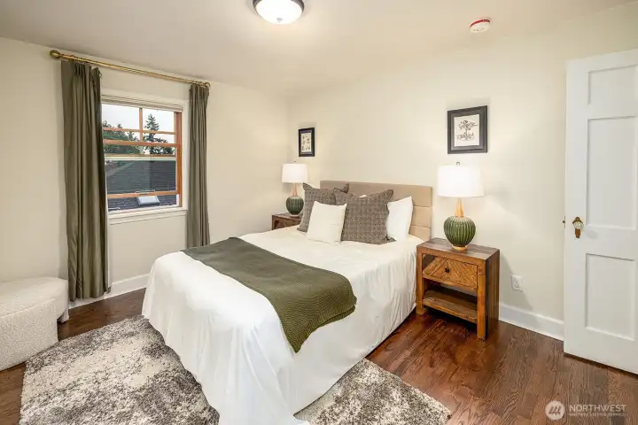 Another view of the bedroom highlights the consistent, thoughtfully selected door hardware carried throughout the home.