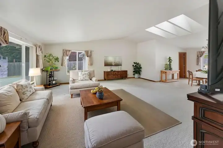 From the entry you'll find this spacious, welcoming great room! This photo is staged and gives you one idea of how you can decorate this space.  The electric console on the right-hand side conveys with the home.