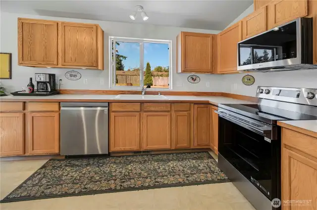 This wonderful, spacious kitchen has oodles of storage and counter space, and you may even enjoy doing the dishes as you overlook your spacious back yard.