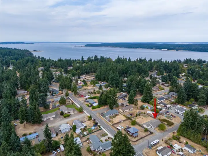 The home is located on the lower right-hand side by the red arrow.  This home is fantastically located near shops, stores, schools, waterfront parks, a boat launch, pharmacies, restaurants and much more!