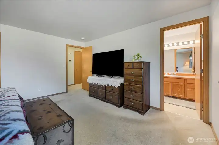 The primary bedroom is large enough for several dresses, ottomans, and a king size bed. On the right-hand side is the private primary bedroom 3/4 bathroom.