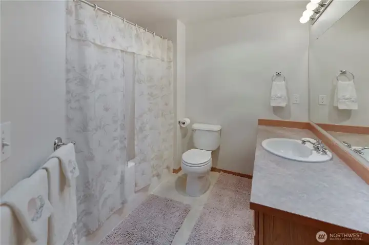 The hallway bathroom has a combo shower/bathtub and is conveniently located by the two guest bedrooms.