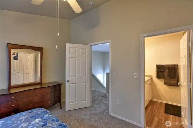 Primary bedroom looking into primary bath. New carpet and laminate flooring in the bathroom.