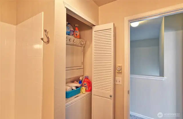 Stackable laundry closet in bathroom.