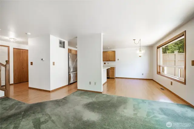 From living room looking to kitchen and dining area. Entry to the left background