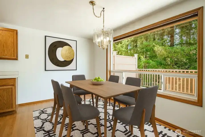 Virtually staged: Dining area overlooking the large deck and woods