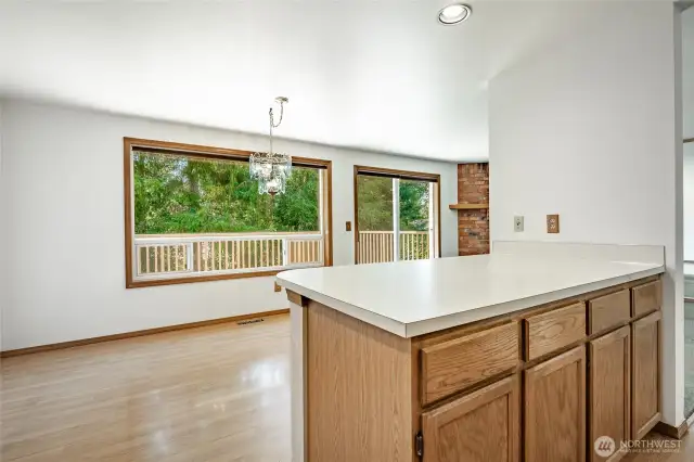 Kitchen/Dining flowing to large backyard deck.