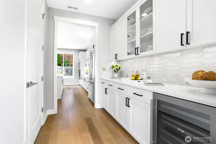 This incredible butler's pantry offers extra storage and a beverage refrigerator.