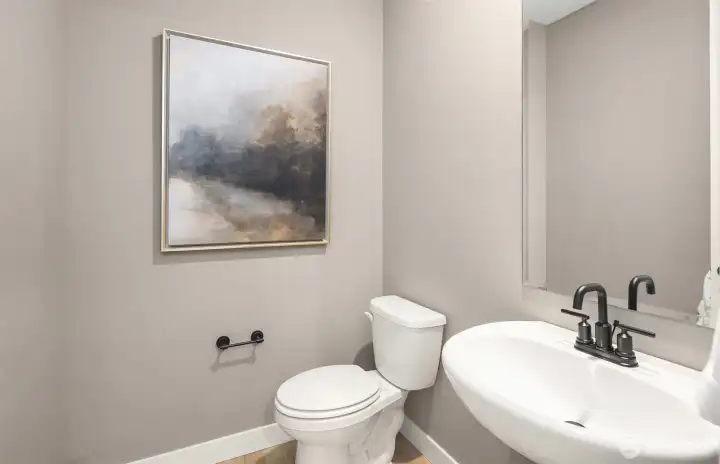 Powder room discreetly located on main floor, similar home