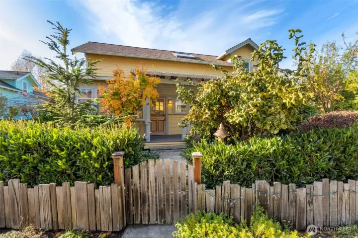 Fenced yard area with established gardens.