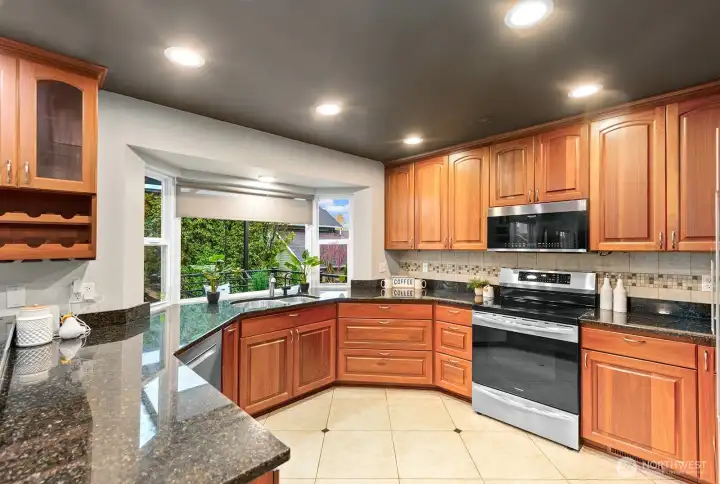 This move-in-ready kitchen features brand-new, high-end Bosch dishwasher and refrigerator and Frigidaire induction stove.