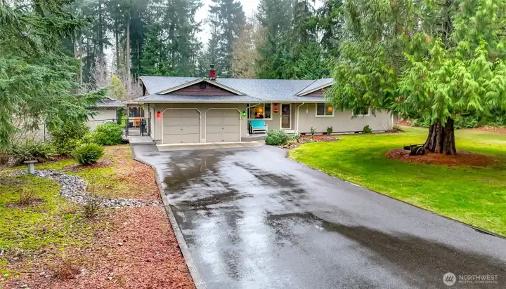 The house sits near the end of a dead-end road. The long driveway offers plenty of space for parking, plus you have a two car garage.