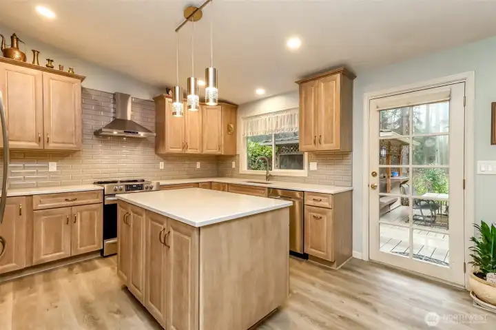 Notice the tilework behind the countertops. There's easy access to the back yard and covered cabana.