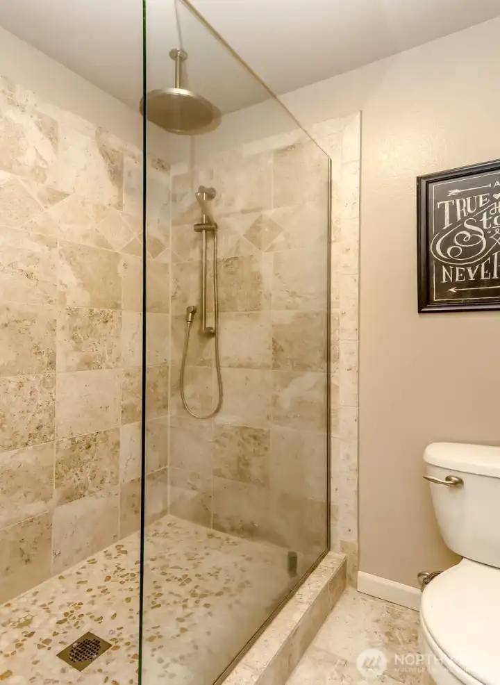 There's an elegantly tiled walk-in shower.