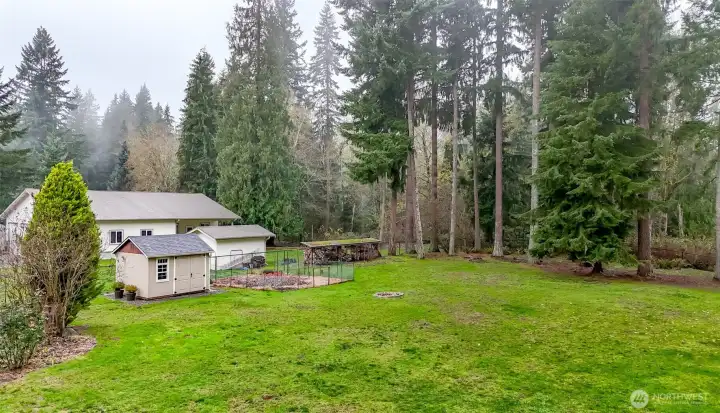 Garden enthusiasts will love the dedicated garden space complete with thriving blueberries and nectarines. There's even a fire pit for enjoyment.