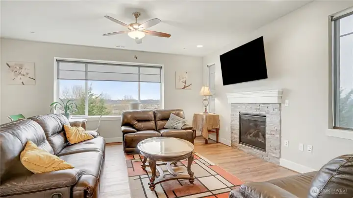 Open main level features a welcoming living area with a cozy fireplace.