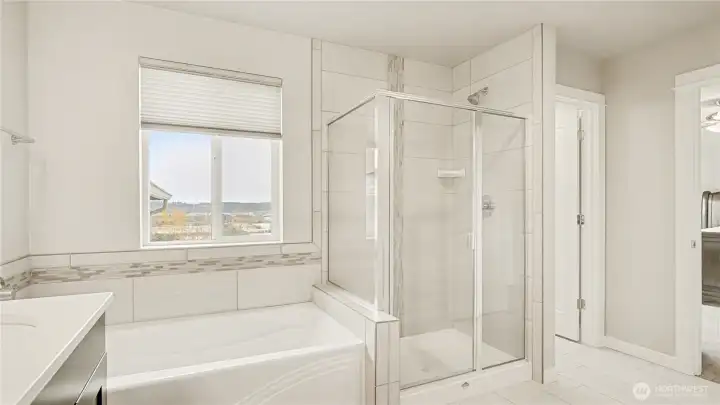 Features both a soaking tub and a standalone shower for ultimate comfort.