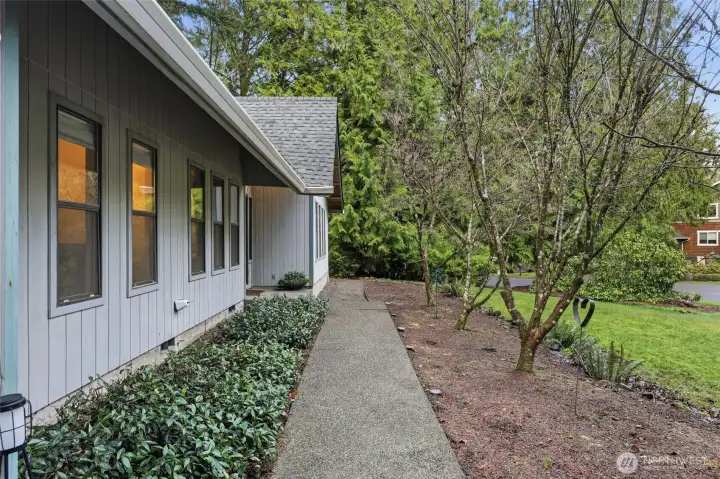 Walkway to front door is charmed by the tidy path and lush greens.  These Dogwoods will take your breath away when full.