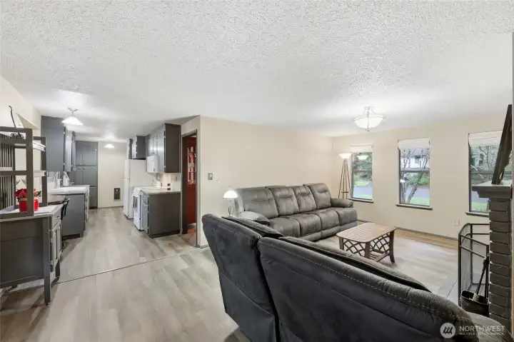 The handsome LVP flooring extends through the kitchen and family room, continuing with another trio of windows to allow light in and provide a view of those beautiful Dogwood trees. Open and fresh, this living space will delight you!