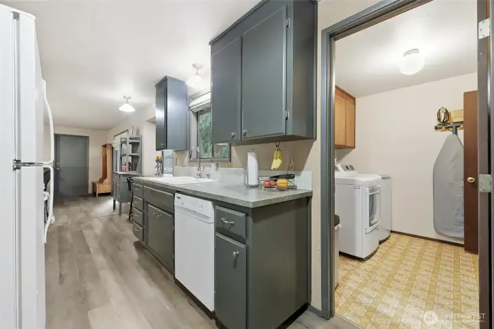 From the other side of the kitchen you'll see the garage door, as well as one of two handy entry points to the laundry room.