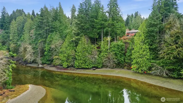 The community park beach stretches in both directions, with the access point from the trail above landing just to the right of center photo here.
