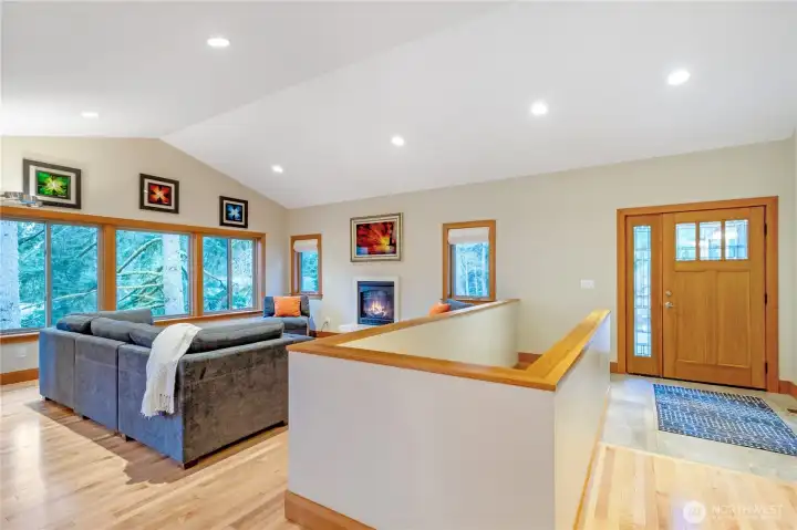 Entry into bright main living space with vaulted ceilings and open layout
