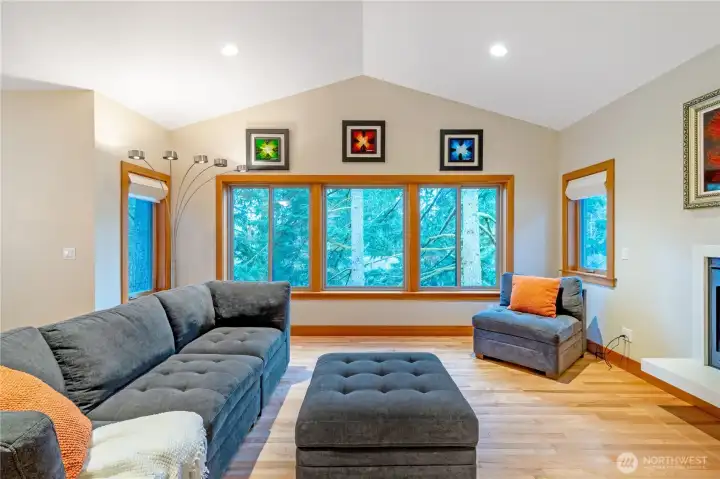 Living room with expansive windows bringing in natural light Living room with expansive windows bringing in natural light