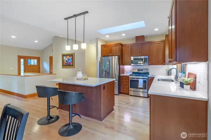 Kitchen featuring quartz counters, stainless appliances, and open layout Kitchen featuring quartz counters, stainless appliances, and open layout