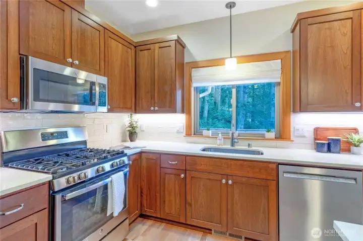Kitchen workspace with window views and abundant cabinetry Kitchen workspace with window views and abundant cabinetry