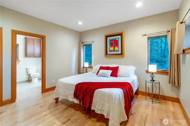 Spacious primary bedroom with large windows and natural light