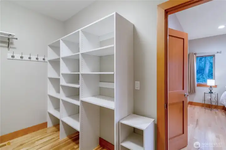 Walk-in closet with built-in shelving and organization Walk-in closet with built-in shelving and organization