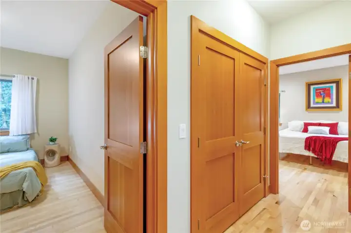 End of hall view of primary bedroom and secondary bedroom