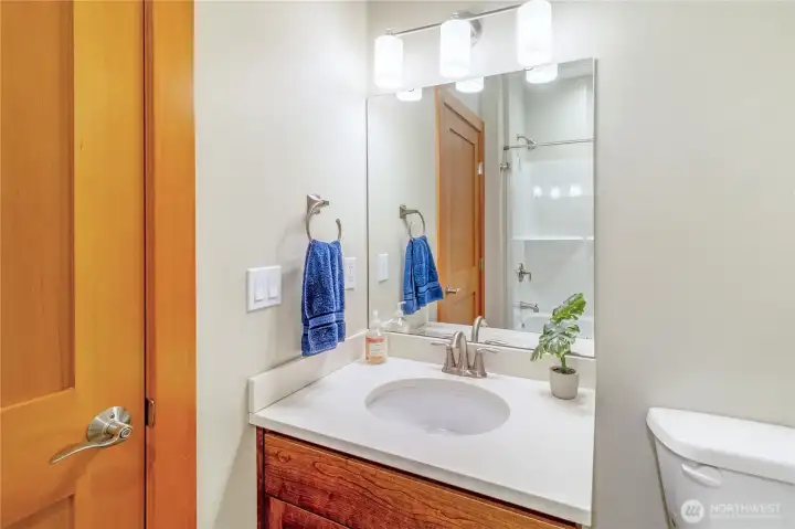 Full bathroom with vanity and storage