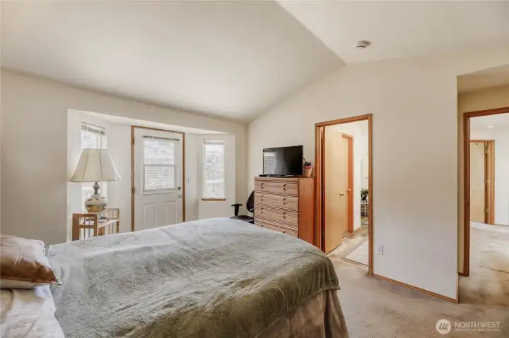 Primary bedroom with a door to the spacious deck (with a view!)