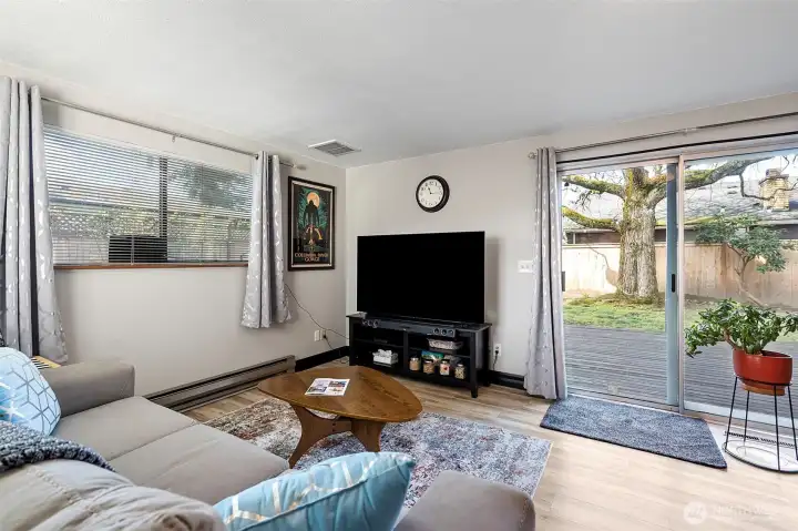 Sliding glass door leads to deck and fully fenced back yard