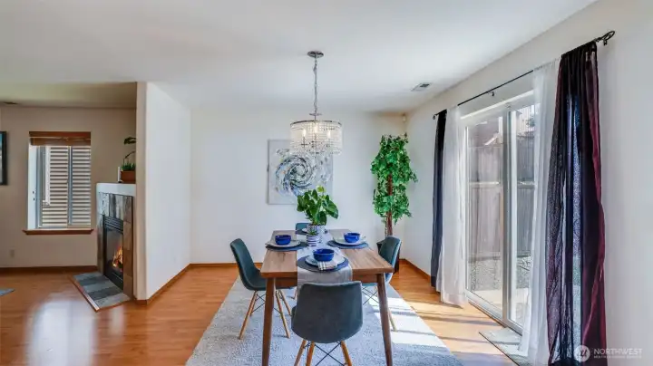 This dining space, with a back door leading to the backyard, is filled with natural light, creating a warm space for you and your guests