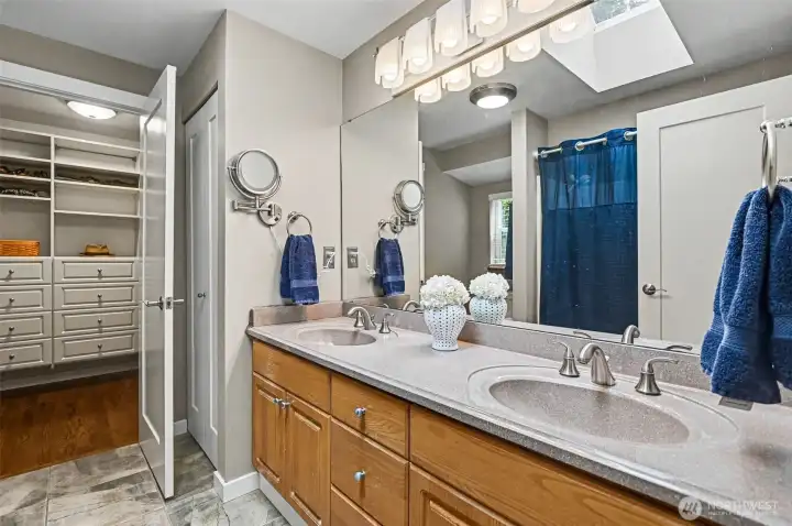 Primary suite with a walk-in closet featuring California Closets.
