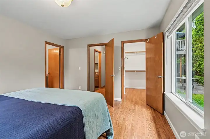 Lower level primary suite with a full bathroom and a walk-in closet.