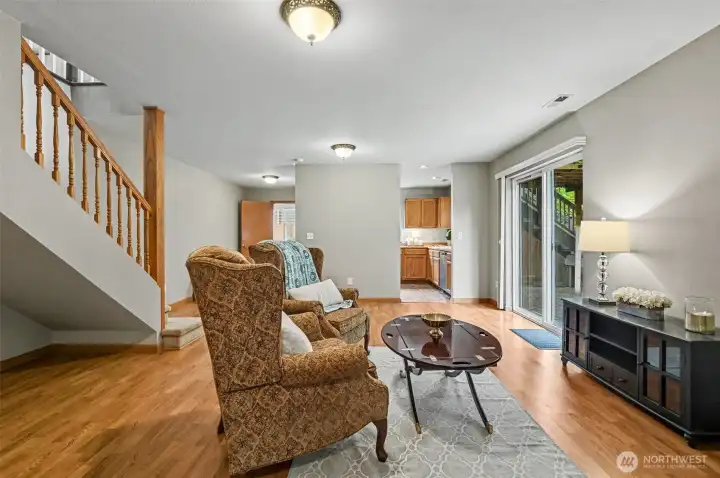 Lower level living room/recreation room with a gas stove and access to the walk-out yard and patio.