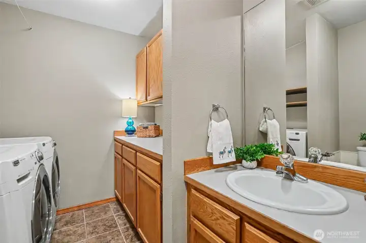 Lower level laundry room with a 1/2 bath.