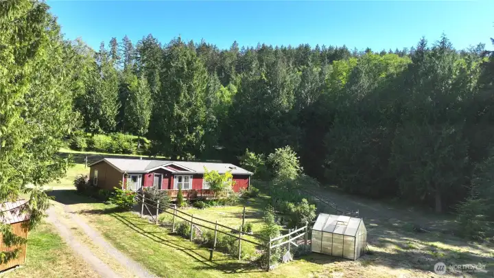 If this photo of the home and garden were the only photo to show the lovely feel of this land, it would do- But this is just the start. Be sure to click through to see all of the different aspects and beautiful areas of this land!   BE SURE TO SEE THE AERIAL LAND PHOTOS AT THE END OF THIS PHOTO SET