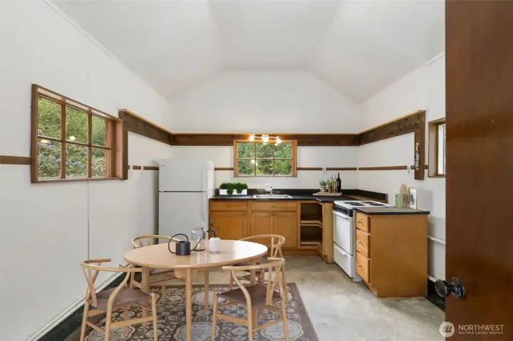 Inside the studio, a sparse but funtional kitchen area with room to detail as you like. workshop, pottery barn, guest quarters? The building is served by a composting toilet.
