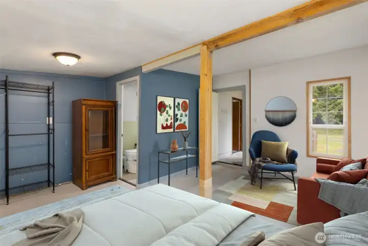 The second room in the studio/shop. Virtually staged as a guest quarters, the kitchen is just through the door. The composting toilet/restroom can be seen here as well.