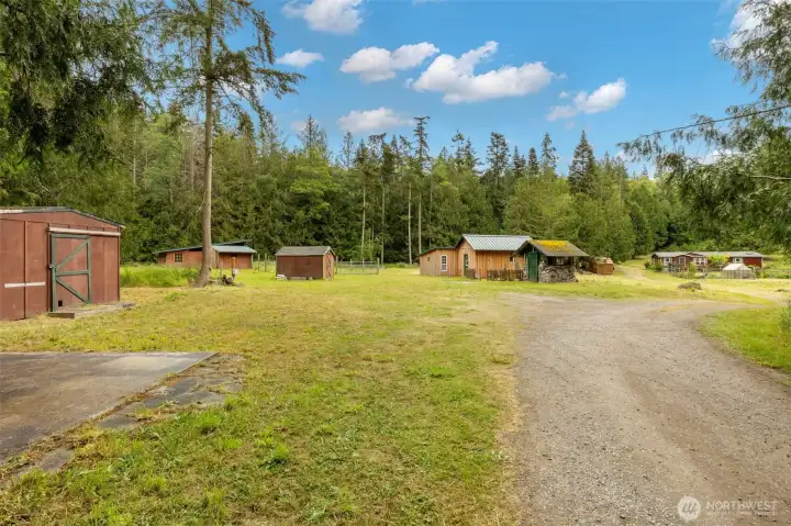 After entering the property, this is the first view you will see. The RV pad is at the bottom left, with  large 'shed' besdie it. more sheds and the stables/barn and animal pen are also shown to the left here.